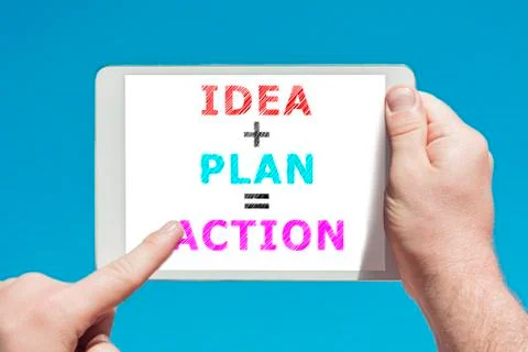 Man holding a tablet device with text idea plan action on the screen Stock Photos