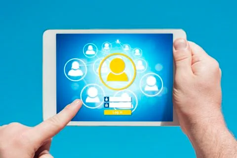 Man holding a tablet device visiting a social network website Stock Photos