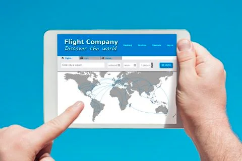 Man holding a tablet device visiting a flight company website Stock Photos
