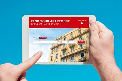 Man holding a tablet device visiting an appartment and house rental website Stock Photos
