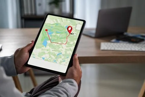 Man holding tablet with GPS navigation app showing map and route, modern di.. Stock Photos