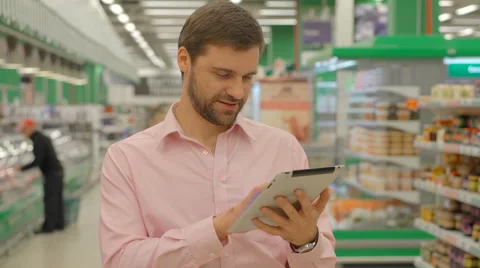 Man holding tablet in hypermarket store Stock Footage 63364799