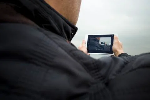 Man holding tablet outside Stock Photos