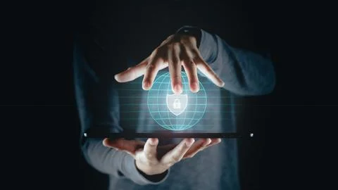 Man holding tablet with padlock shield protects security icon on the virtua.. Stock Photos