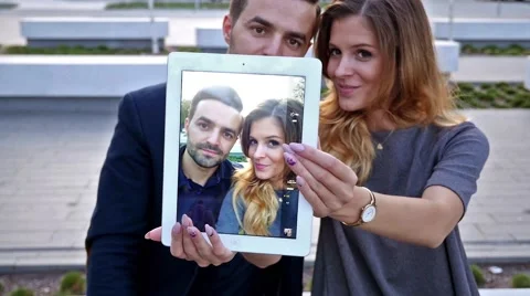 Man is holding tablet pc and trying to take a  selfie. Positive emotions Video stock 56304836