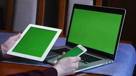 Man is holding tablet pc and mobile hone. Laptop is on the table. Close up. Video stock 61281071