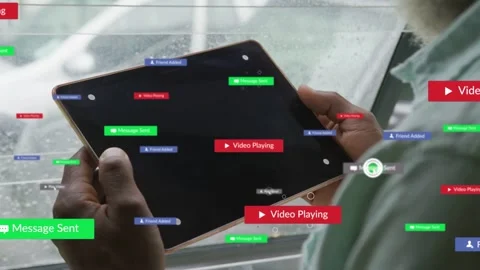 Man holding tablet by rainy window, his cursor clicking play causing badges Stock Footage 334203212