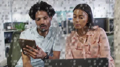 Man holding tablet showing screen, team reviewing tech data on laptop as binary Stock Footage 332625440