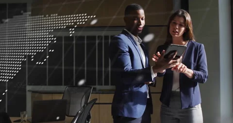Man holding tablet while woman tapping screen, overlay shifting code and world Stock Footage 311216980