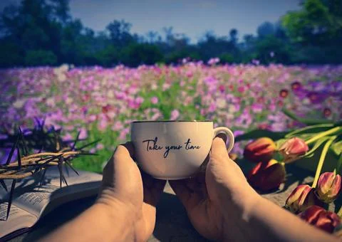 Man Holding Tea Cup. Spring Background. Stock Photos