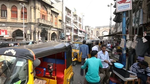 Man holding tea walks through crowded street Stock Footage 84625525