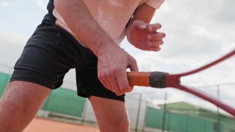 Man Holding Tennis Racket in Ready Position on Clay Court Stock Footage 345029400