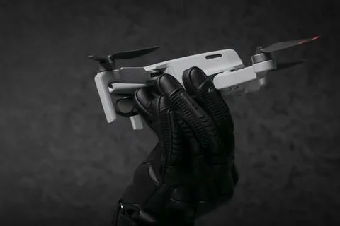 A man holding up a tiny propeller for a camera or photo Foto stock