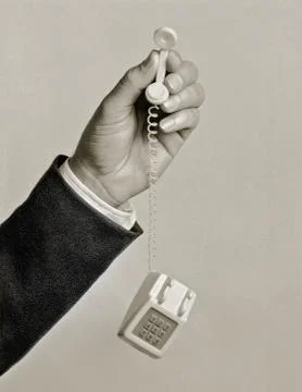 Man holding tiny toy phone Stock Photos