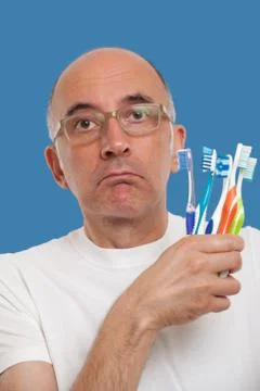 Man holding toothbrushes Stock Photos