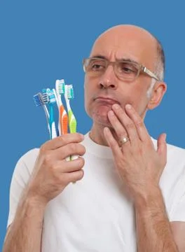 Man holding toothbrushes Stock Photos