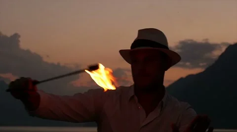 Man holding torchlight playing with flame. romantic night light Stock Footage 42947381