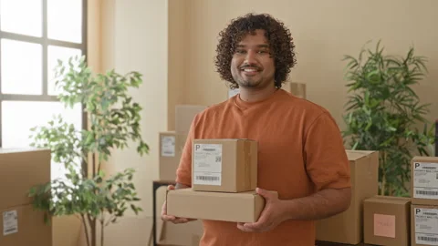 Man holding two cardboard boxes and smiling in building office, parcel labe.. Stock Footage 337402652
