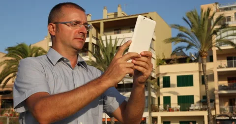 Man Holding Using Digital Tablet Exotic Island Idyllic Location Buildings Travel Stock Footage 67904741
