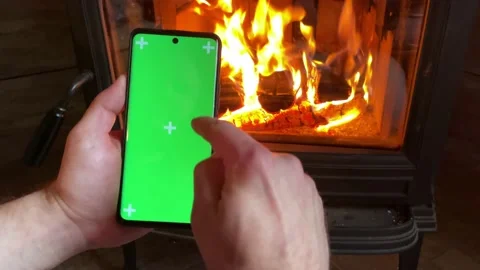 Man Holding a Vertical Green Screen Smartphone Stock Footage 220712507
