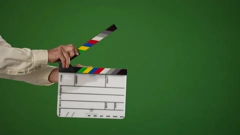 Man holding video cinema clapper board and opening and clapping it shut on a 스톡 동영상 166736882