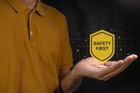 Man holding a virtual Safety First symbol. Safety first concept. Stock Photos