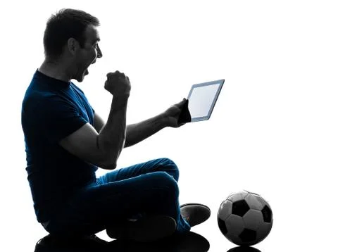 Man holding watching digital tablet  silhouette Stock Photos