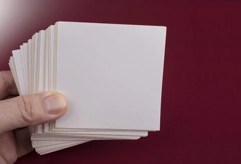 Man holding white note papers on red Stock Photos