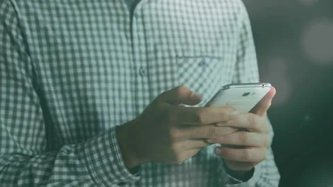 Man holding white smartphone and tapping screen, initiating animated UI charts Stock Footage 333894485