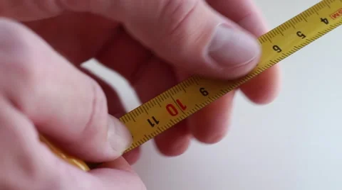 Man holding a yellow centimeter 動画素材 64621516
