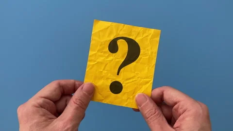 A man holding a yellow paper note with a Question mark on it. Stock Footage 301548590