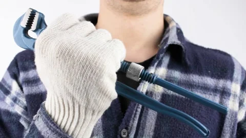A man holds an adjustable wrench in his hand. Stock Footage 208908155