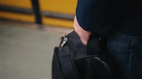A man holds a bag in his hand while he rides the subway. Close-up shooting Stock Footage 336100720