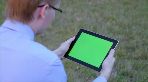 Man holds a blank digital tablet computer with a green screen Vidéo 68057038