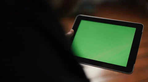 A man holds a blank tablet PC with a green screen for your own custom content. Vídeos de archivo 62023097