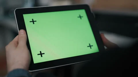 A man holds a blank tablet PC with a green screen for your own custom content. Vídeos de archivo 62026021