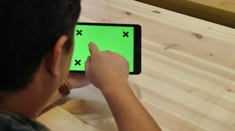 A man holds a blank tablet PC with a green screen for your own custom content. Stock Footage 62890732