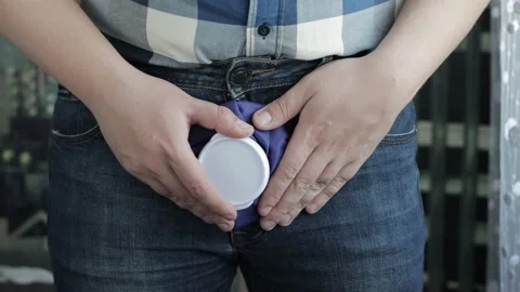 A man holds a blue ice bag near his groin. Treatment of male diseases with cold Stock Footage 217902474