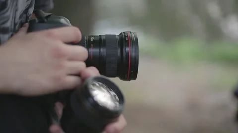 Man holds a camera and lens closeup Stock Footage 61248468