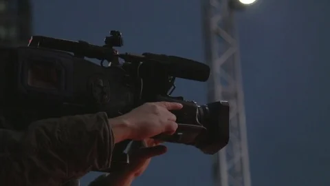 A man holds a camera in the hands of black Stock Footage 73031681