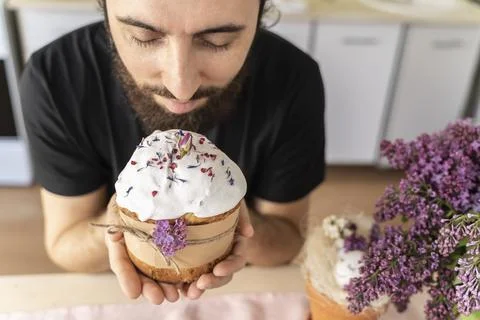 Man holds close-up of an Easter cake in his hands. Traditional pastries for Stock Photos