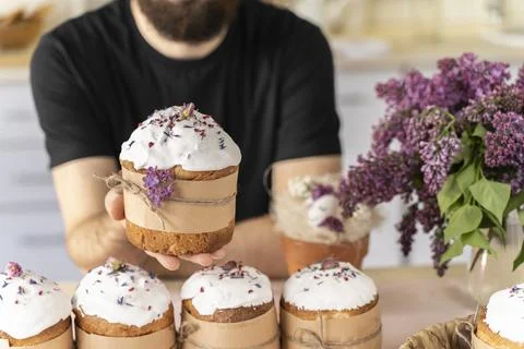 Man holds close-up of an Easter cake in his hands. Traditional pastries for Stock Photos