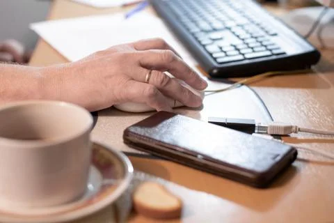 A man holds a computer mouse in his hands Stock Photos