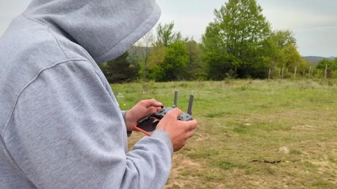 A man holds a control panel in his hands in nature. Stock Footage 242172035