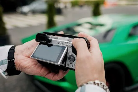 Man holds a digital camera Stock Photos