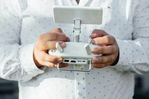 Man holds a drone remote controller in his hands. Close-up of quad copter RC Stock Photos