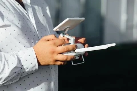 Man holds a drone remote controller in his hands. Close-up of quad copter RC Stock Photos