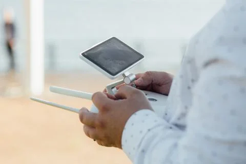 Man holds a drone remote controller in his hands. Close-up of quad copter RC Stock Photos
