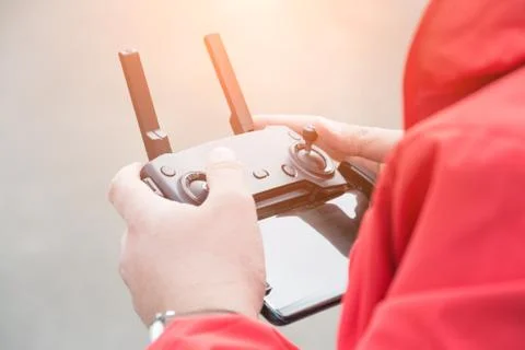 Man holds a drone remote controller in his hands Stock Photos