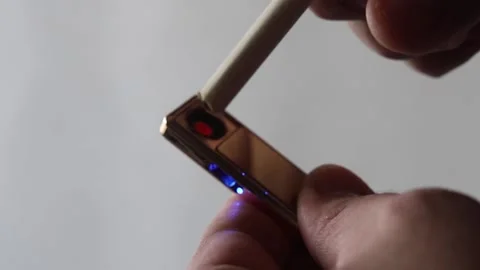 Man Holds electronic usb lighter In His Hand And Lights A Cigarette. Stock Footage 164529864